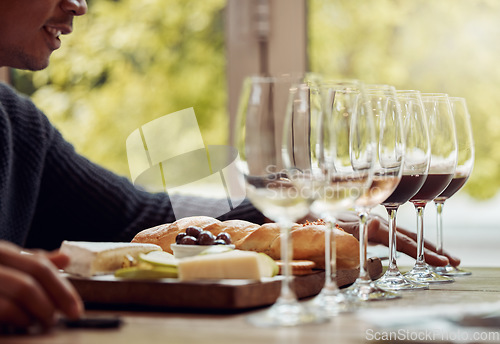 Image of Wine tasting, cheese platter and luxury restaurant with alcohol and glass for customer. Eating, drink and sommelier with bottle for wines and food pairing in a fine dining and winery experience