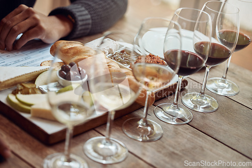 Image of Wine tasting, cheese board and winery restaurant with alcohol and glass for customer. Eating, drink and person with rich wines and food pairing in a fine dining and luxury snack experience alone