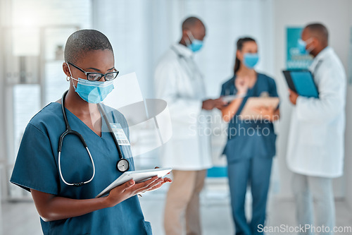 Image of Healthcare, doctor and black woman on tablet with face mask for research, medical report and results. Hospital, clinic and female worker on digital tech for online service, consulting app or internet