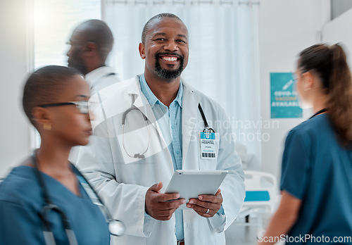 Image of Busy hospital, tablet and portrait of doctor for medical care, wellness app and support with blur of people. Healthcare, digital tech and happy black man for service, consulting and health insurance