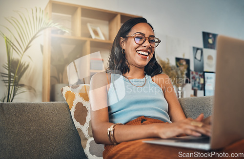 Image of Laptop, young woman laugh and work from home with a smile writing for website. Happy freelancer, living room sofa and female person blogging on a lounge couch and typing a blog post on a computer