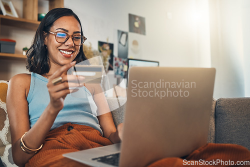 Image of Woman on couch with laptop, credit card and online shopping, payment and ecommerce with fintech at home. Happy female customer at apartment, bank app and sale on store website with internet banking