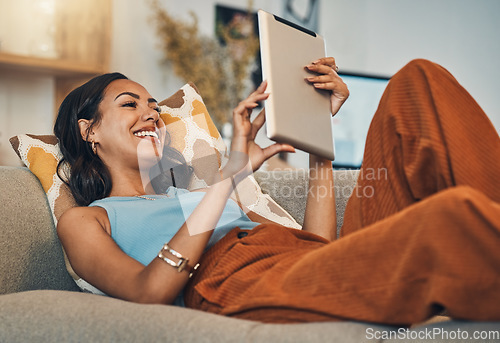 Image of Woman relax on sofa with tablet, online streaming with internet and reading ebook or watching film at home. Happy female person with technology, subscription and mobile app with break in living room