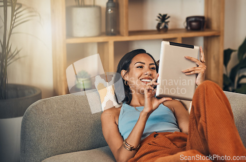 Image of Woman relax on couch with tablet, online streaming with internet and reading ebook or watching film at home. Happy female person with technology, subscription and mobile app with break in living room