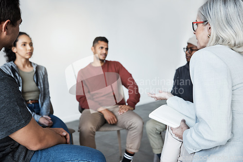 Image of Counselling, psychologist and group of patients at a therapy session for mental health or depression. Community, diversity and people or friends in a circle talking to therapist at psychology center.