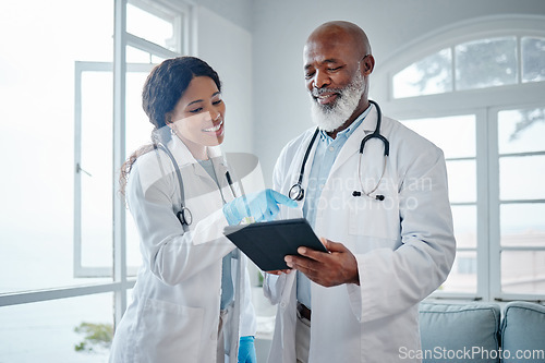 Image of African doctors, teamwork and talk with tablet, data analysis or learning for healthcare in hospital. Senior black man, woman or medical mentor on touchscreen for research with wellness app in clinic