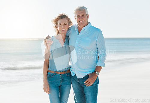 Image of Mature, couple and beach with portrait on vacation hold for happiness or travel in summer. Senior, woman and man hug at the ocean on holiday in the outdoor with smile and sun for retirement.