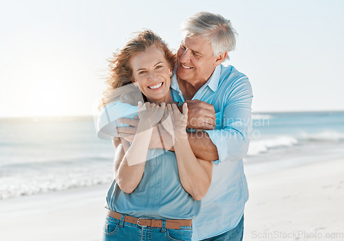 Image of Senior, couple and portrait hug by the ocean with happiness and love on holiday in the outdoor. Mature, man and woman at the beach hugging on vacation with smile for travel together with sunshine.