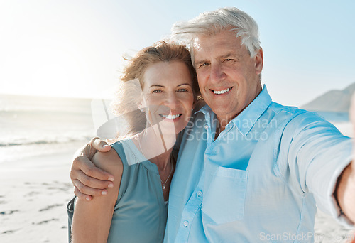 Image of Senior, couple and selfie at the beach with portrait for happiness on holiday for the weekend. Mature, woman and man hug at the ocean for closeup and smile in the outdoor on vacation for retirement.