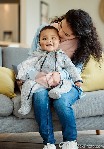 Image of Kiss, portrait and mother with baby in living room home, bonding or having fun in house. Mom, newborn and kissing face of happy child on sofa for care, love and affection for family time together.