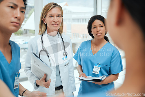 Image of Teamwork, talking or doctors with leadership in meeting planning a surgery strategy in collaboration. Discussion, nurses or surgeons speaking of healthcare paperwork documents or research report