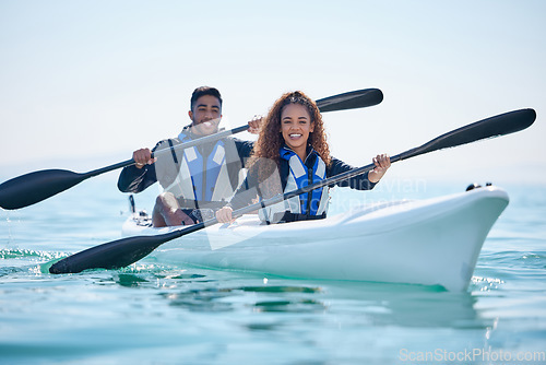 Image of Kayak, rowing and couple on a boat at ocean, lake or river for water sports or fitness challenge. Portrait of happy man and woman with a paddle for adventure, teamwork exercise or travel in nature