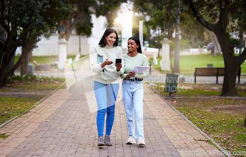 Image of Happy, female students and friends with a smartphone walking together at university reading exam test results on a mobile app. Technology, smile and college girls on social media or chat on campus