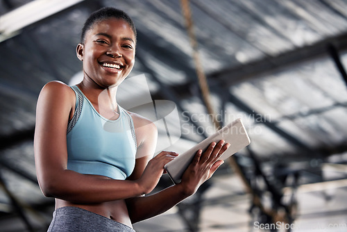 Image of Black woman, portrait or personal trainer with a tablet for fitness training, workout or sports exercise. Results, digital technology app or happy gym instructor planning a online coaching schedule