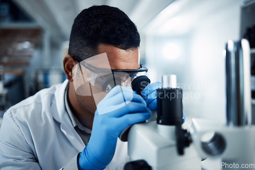 Image of Man, scientist and microscope in forensic science research, discovery or data analysis at lab. Male person or medical professional in scientific results for cure, virus or vaccine in laboratory