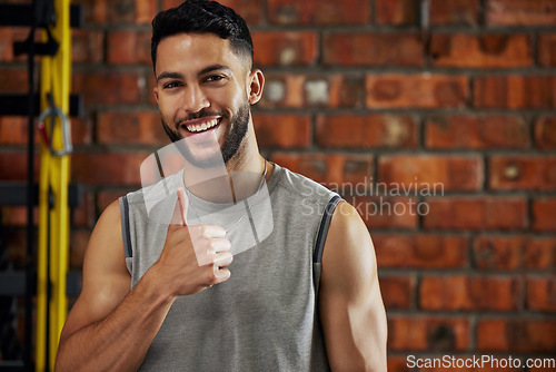 Image of Fitness, thumbs up and portrait of man in gym, motivation and confident smile with agreement emoji. Happiness, workout and happy face of bodybuilder with winning hand gesture for health and training.