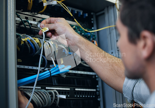 Image of Server room, technician and hands of man with cable for programming, cybersecurity or maintenance. IT person in datacenter for network connection, software or system upgrade for internet or hardware