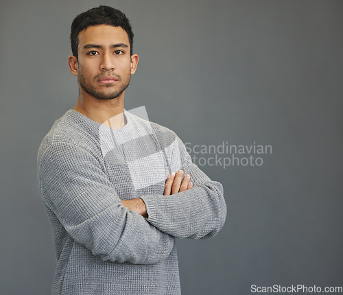 Image of Serious portrait of man in studio with mockup, arms crossed and model on studio backdrop in casual fashion. Relax, confidence and face of male on grey background with focus, pride and mock up space.