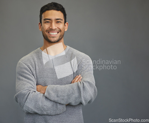 Image of Portrait of man with mockup, arms crossed and smile on studio backdrop in confident casual fashion promo. Relax, confidence and face of male on grey background with happiness, pride and mock up space