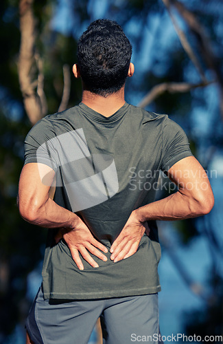 Image of Man, back pain and fitness injury outdoor after accident, exercise or sports workout. Spine, problem and male athlete with arthritis, fibromyalgia emergency or muscle inflammation for wound in forest