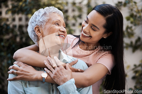 Image of Happy, hug and loving of a mother and woman in a garden on mothers day with care and gratitude together. Smile, family and an adult daughter hugging a senior mom in a backyard or park for happiness