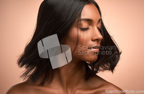 Image of Motion, beauty and woman in studio with a hair care, keratin and healthy salon treatment. Wellness, luxury and female model shake her shiny, clean and soft hairstyle or haircut by a brown background.