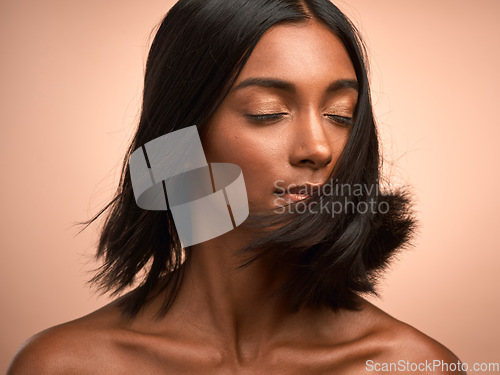 Image of Hair care, shake and woman in studio for beauty, keratin and healthy salon treatment. Wellness, cosmetic and young female model with motion for shiny, clean and soft hairstyle by a background.