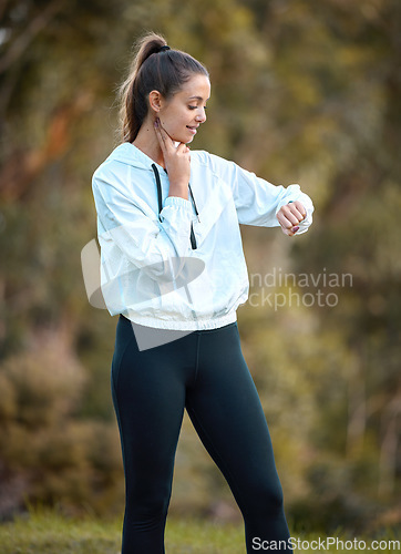 Image of Fitness, watch and heart rate with a woman runner outdoor checking pulse during a cardio or endurance workout. Exercise, health and bpm with a young female athlete looking at the time while running