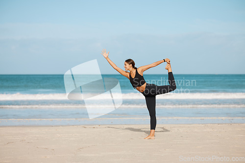 Image of Stretching, woman and yoga on the beach for exercise, fitness or wellness workout for healthy, holistic or zen mindset. Girl, stretch and meditation at ocean, sea or outdoor pilates training