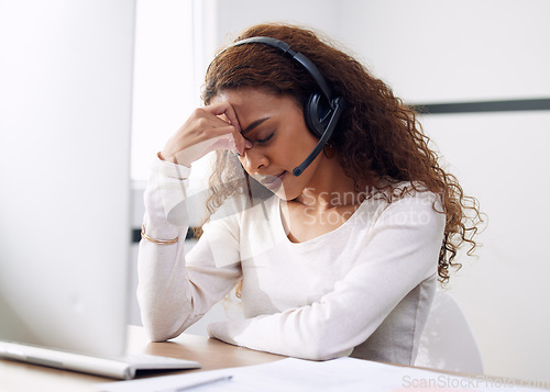 Image of Call center, woman and headache at computer for stress, burnout and problem with client communication. Tired female telemarketing consultant at desktop with crisis, challenge and bad sales service