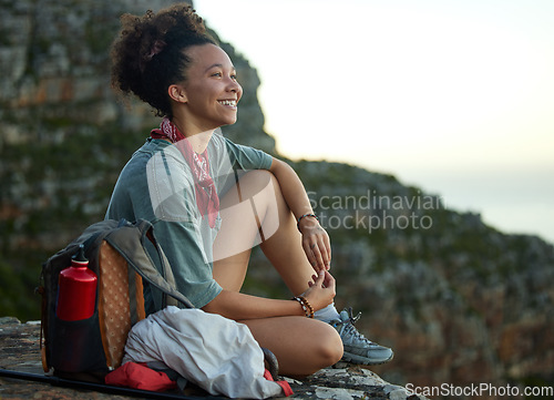 Image of Woman, hiking and mountain top for happiness and wellness and adventure in south africa. Female hiker, smile and cliff for scenery in outdoor in the morning with motivation for exercise in nature.