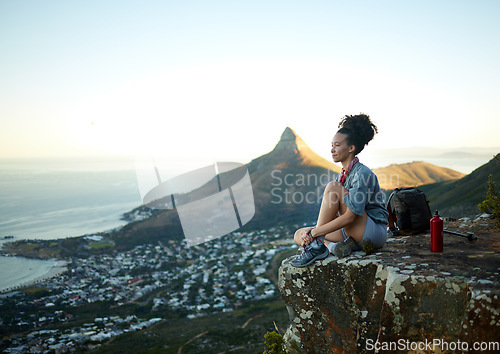 Image of Woman, mountain and sitting with view of cityscape outdoor for exercise in Cape Town. Female hiking, cliff and South Africa for adventure in nature in the morning for wellness on the weekend.