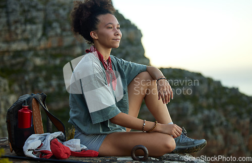 Image of Woman, hiking and resting on a mountain top with view for wellness and fitness in south africa. Female hiker, sitting and cliff with sunset in the outdoor for adventure and exercise for relaxing.