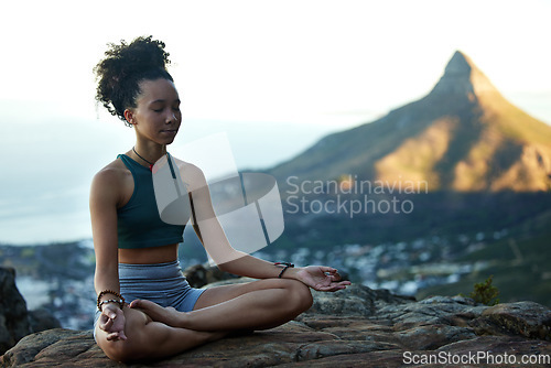 Image of Woman, mediation and yoga on a mountain with wellness in cape town for fitness and health. Female hiker, calm and meditating on a cliff in the outdoor with nature cityscape for healthy body.