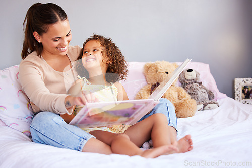 Image of Happy, book and mother with daughter in bedroom for storytelling, fantasy or creative. Education, learning and love with woman reading to young girl in family home for fairytale, literature and relax