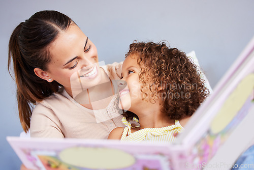 Image of Love, book and relax with mother with daughter in bedroom for storytelling, fantasy or creative. Education, learning and smile with woman reading to girl in family home for study, happy and fairytale