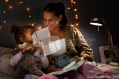 Image of Night, book and learning with mother with daughter in bedroom for storytelling, fantasy and smile. Education, fairytale and love with woman reading to girl in family home for bedtime, happy or relax