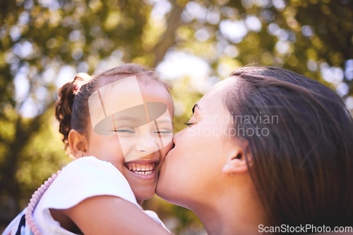 Image of Girl, mother and kiss cheek in nature, funny and bonding on summer holiday vacation. Mom, kissing and happy child, love and affection, care and enjoying quality family time together outdoor in park.