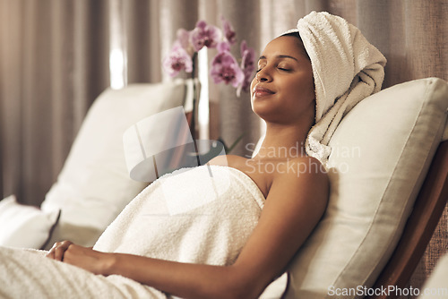 Image of Spa, woman and relax on chair for calm, zen and peace for physical therapy, health and wellness. Female customer with eyes closed, luxury and towel for a holistic massage and hospitality at a salon