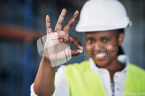 Image of Black woman, architect and hands with okay sign for construction success, good job or precise on site. Hand of happy African female person engineer showing OK emoji, yes or perfect in architecture