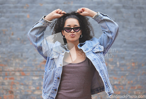 Image of Fashion, attitude and portrait of woman on wall background in trendy, stylish and urban clothes. Beauty, freedom and happy female person pose in city with sunglasses, confidence and style outdoors