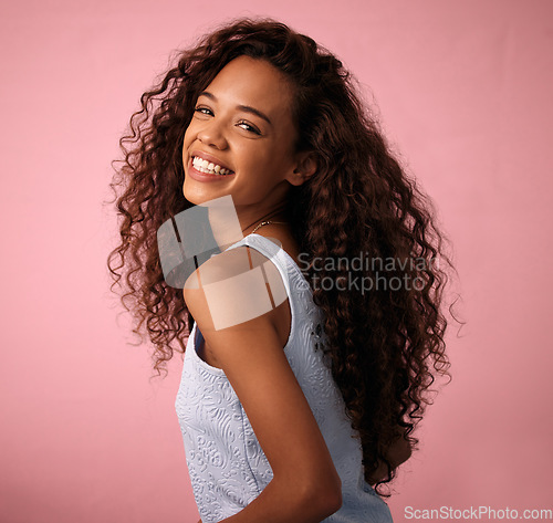 Image of Hair care, portrait and woman in a studio with a natural, long and curly beauty salon hairstyle. Happy, smile and brunette female model with a keratin cosmetic treatment isolated by pink background.