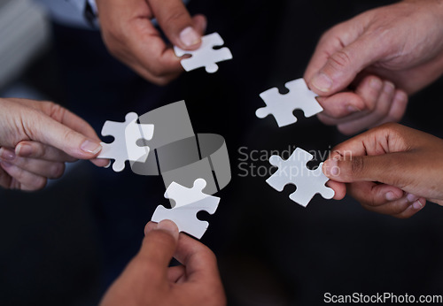 Image of Puzzle, teamwork and support with hands of business people for synergy, partnership or trust. Integration, problem solving and solution with employees and jigsaw for mission, collaboration or process