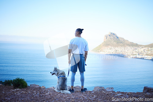 Image of Nature, lake and man with dog in mountain for hiking, walking and fresh air together outdoors. Traveling, friendship and back of male person with pet husky relax for freedom, adventure and exercise