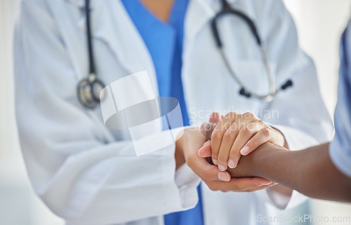 Image of Doctor, holding hands and patient with support, help and grief consulting after cancer news. Hospital, healthcare and clinic worker with person supporting with guidance and advice from health results