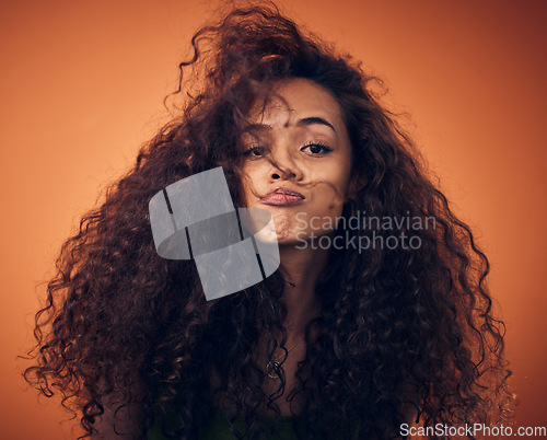 Image of Portrait, beauty and woman with hair care, curly and volume against a studio background. Face, female person and model with salon treatment, wavy and grooming with cosmetics for hairstyle and growth
