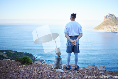 Image of Mountain, lake and back of man with dog for hiking, walking and fresh air together outdoors. Traveling, friendship and male person with pet husky relax for freedom, adventure and exercise in nature