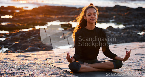 Image of Woman, beach yoga and sunset with lotus, eyes closed and peace of mind in summer sunshine. Girl, zen meditation and mindfulness for health, wellness and exercise by ocean, chakra balance and energy