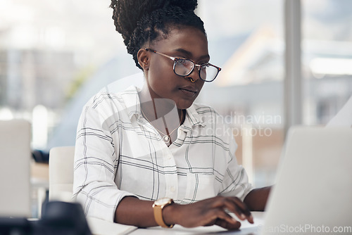 Image of Laptop, typing and business woman for online research, editing or copywriting at her office desk with email. Planning, working and african person, editor or employee on computer for blog or article