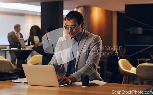 Image of Laptop, corporate lobby and business man review economy report, online analysis or typing web feedback. Night reading, coworking and finance person doing research, computer search and financial work